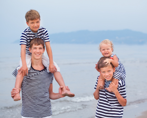 Portrait of happy  cheerful brother and little cutesister on sea background, italy,