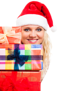 Attractive woman in Santa hat with Christmas gifts
